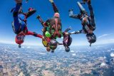 Small group of experienced skydivers in head down formation
