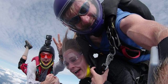 Tandem skydiving student in freefall with instructor and videographer skydiving in Oregon at PNW Skydiving