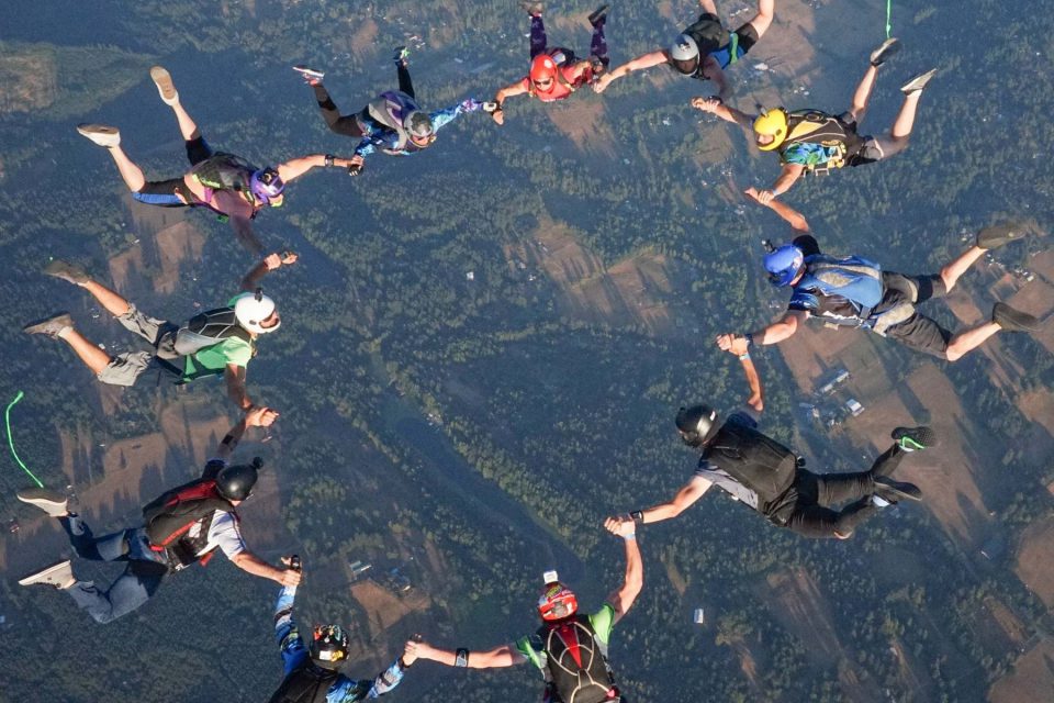 Licensed skydivers in circular freefall formation over PNW Skydiving near Portland, OR