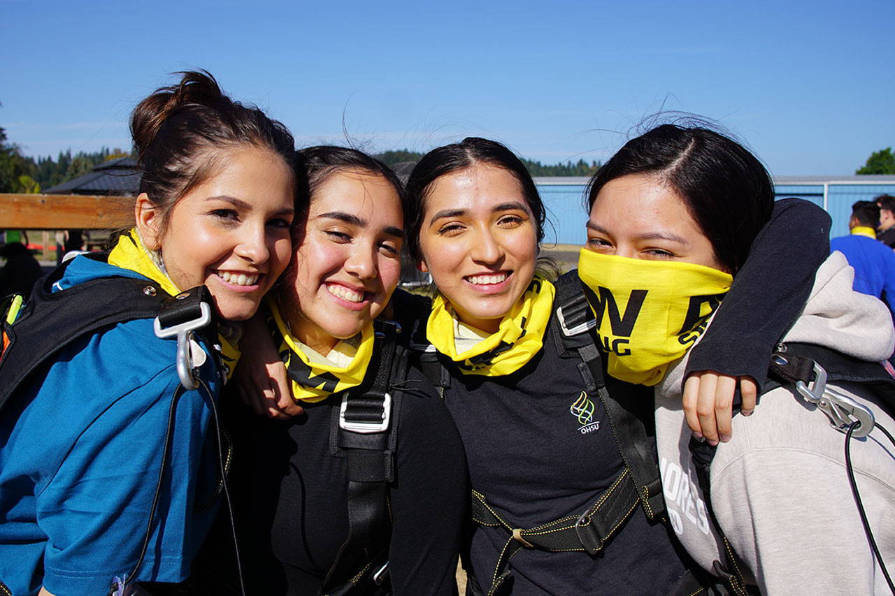 four girls embrace before skydiving at PNW Skydiving