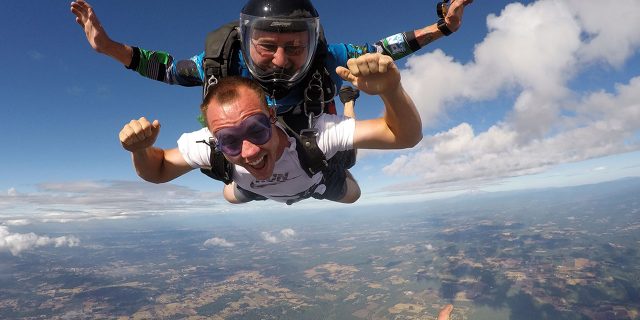 male tandem student smiles in freefall