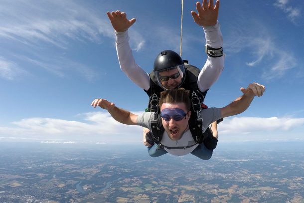 young man enjoying skydiving freefall